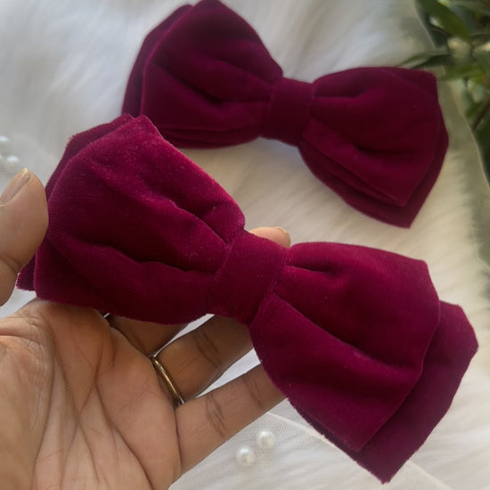 Close-up video of the Runaway Diva Hair Bow Clip, showcasing its rich magenta pink premium velvet fabric for a bold and luxurious design.