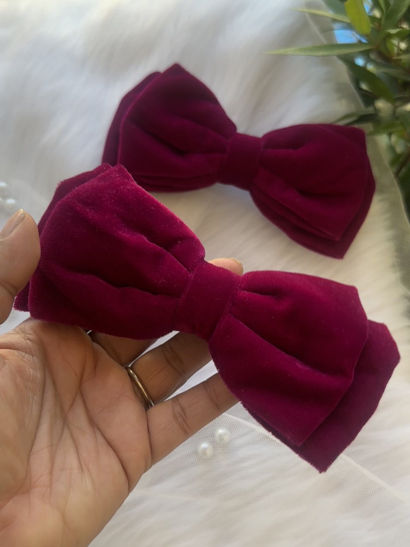 Close-up video of the Runaway Diva Hair Bow Clip, showcasing its rich magenta pink premium velvet fabric for a bold and luxurious design.