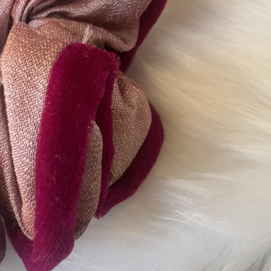 Close-up video of the Damask Roses Scrunchie, showcasing its smooth silk fabric, plush deep pink velvet border, and secure elastic band in motion