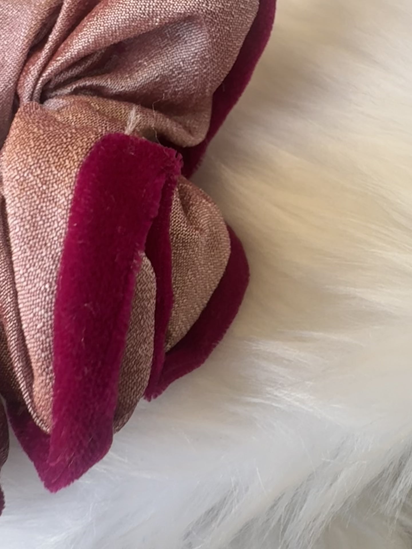 Close-up video of the Damask Roses Scrunchie, showcasing its smooth silk fabric, plush deep pink velvet border, and secure elastic band in motion