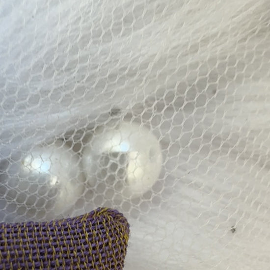 Close-up video of the Blackcurrant Ice Hair Bow Clip, showcasing its soft light brown cotton fabric and timeless bow design for effortless elegance.