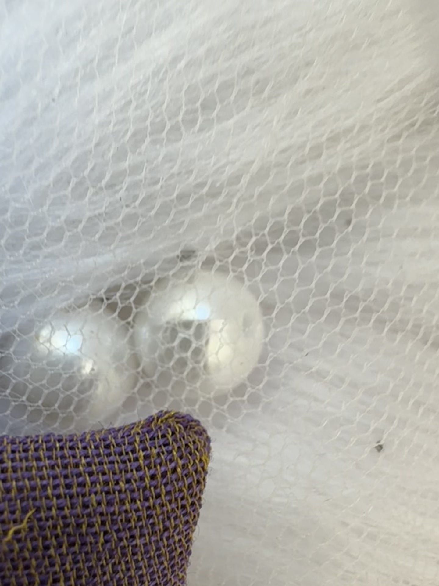 Close-up video of the Blackcurrant Ice Hair Bow Clip, showcasing its soft light brown cotton fabric and timeless bow design for effortless elegance.