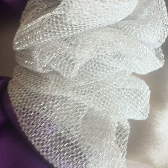 Close-up video of the Purple Silver Snow Scrunchie, showcasing its deep purple satin and shimmering silver net fabric for a luxurious and elegant design.