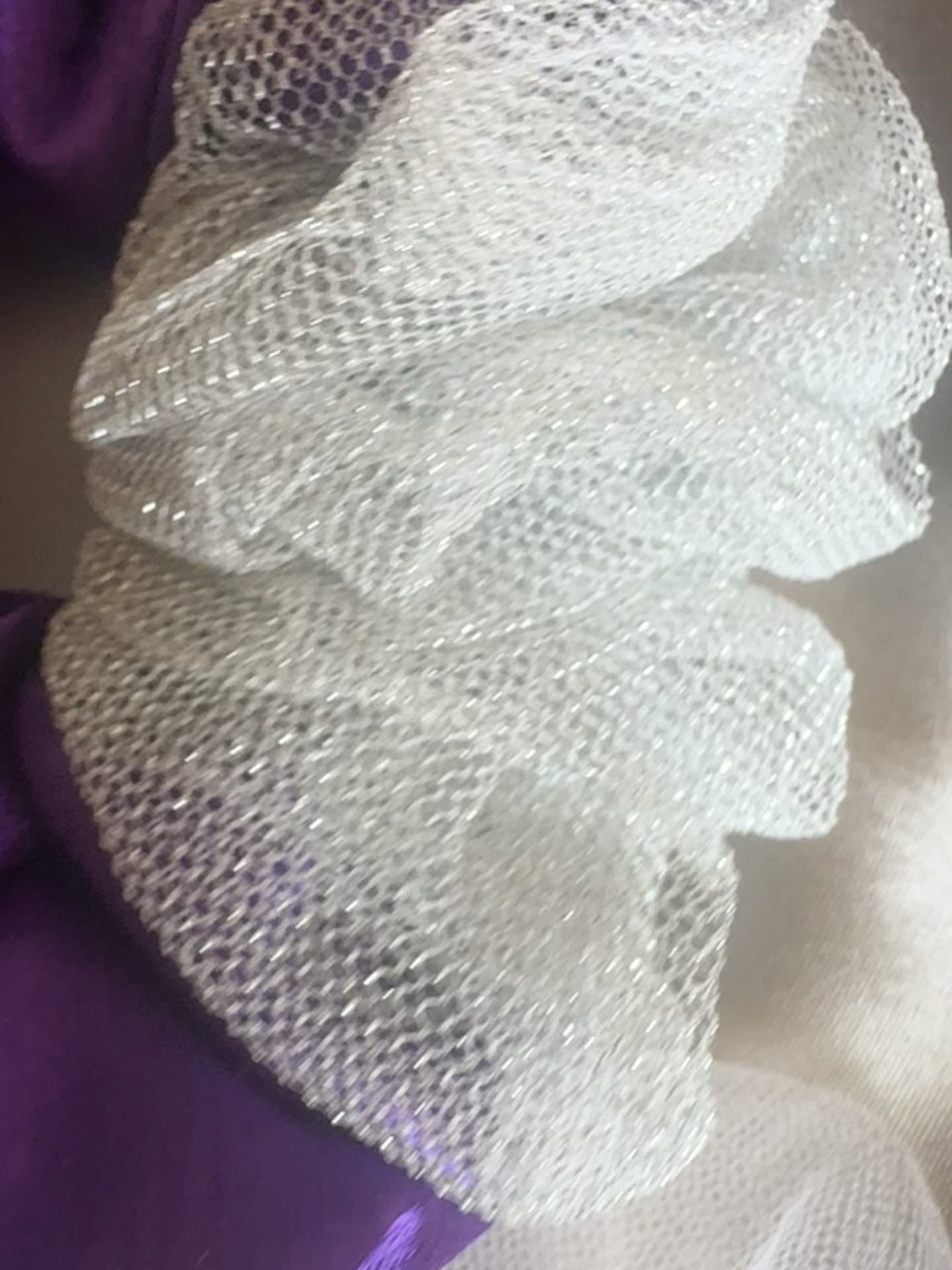 Close-up video of the Purple Silver Snow Scrunchie, showcasing its deep purple satin and shimmering silver net fabric for a luxurious and elegant design.