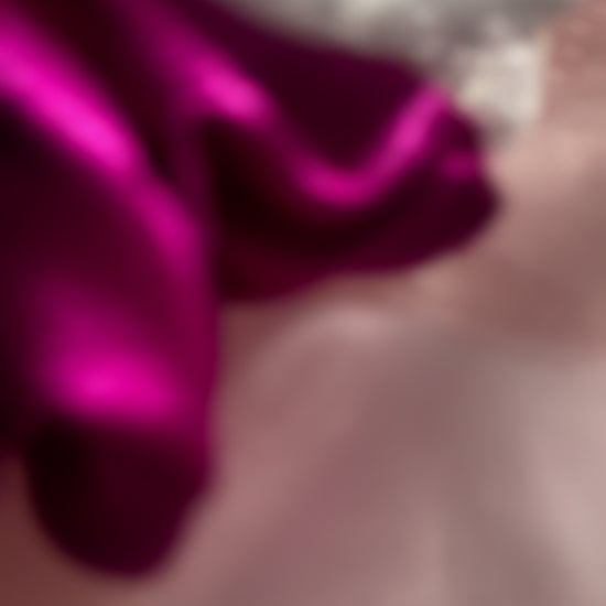 Close-up video of the Pink Silver Snow Scrunchie, highlighting its soft satin fabric, shimmering silver net detailing, and strong yet gentle elastic band.