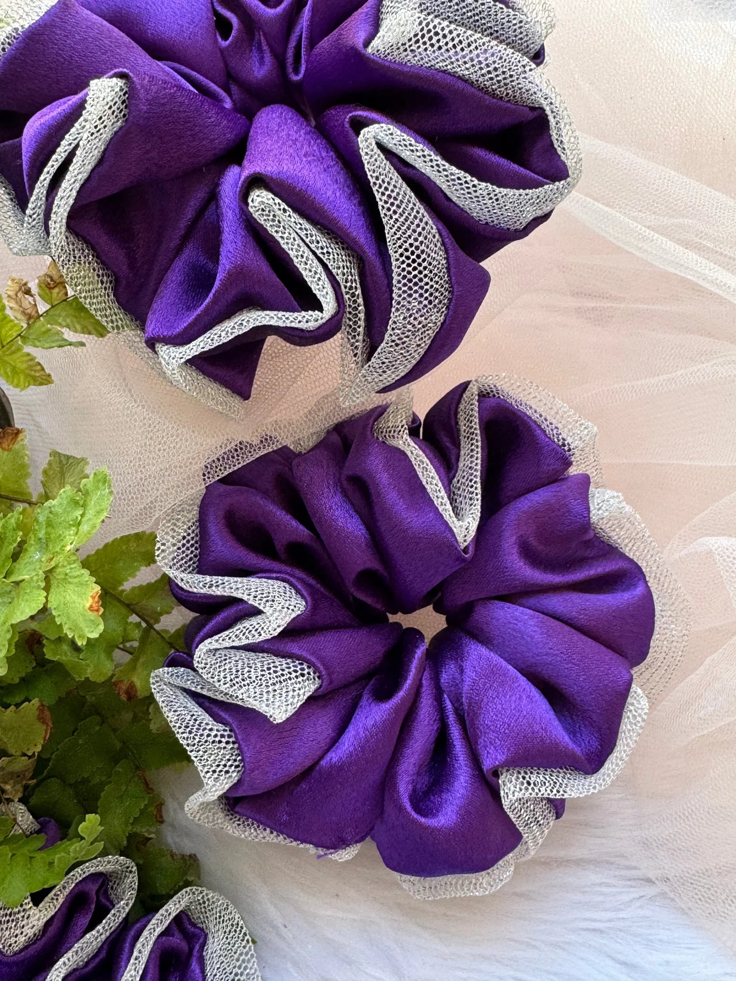 Purple satin scrunchies with silver net border detail by Bows and Bags India, handmade hair accessories, close-up texture