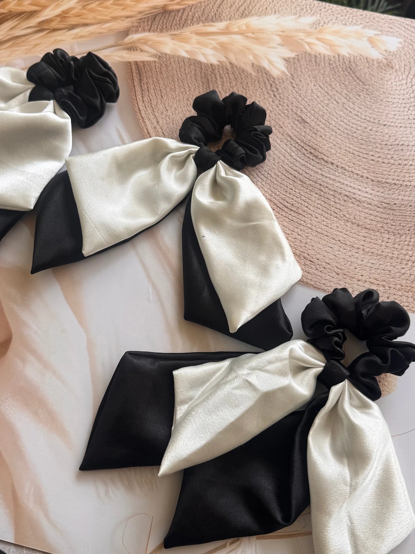 Black and white satin dual long tail scrunchies with bow details by Bows and Bags India, handmade hair accessories displayed