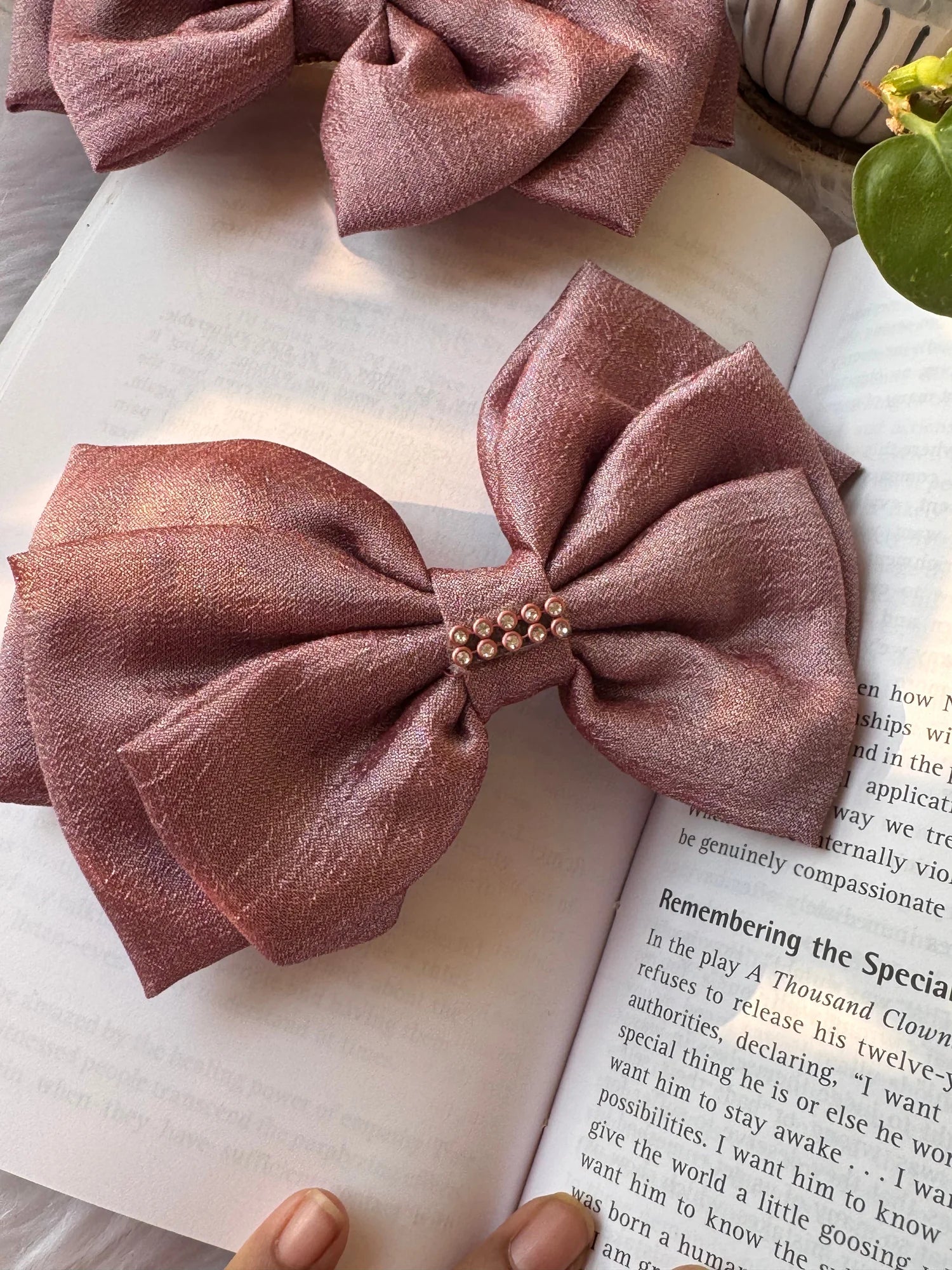 Rose gold silk hair bow with stone embellishment on book, Bows and Bags India handmade accessory