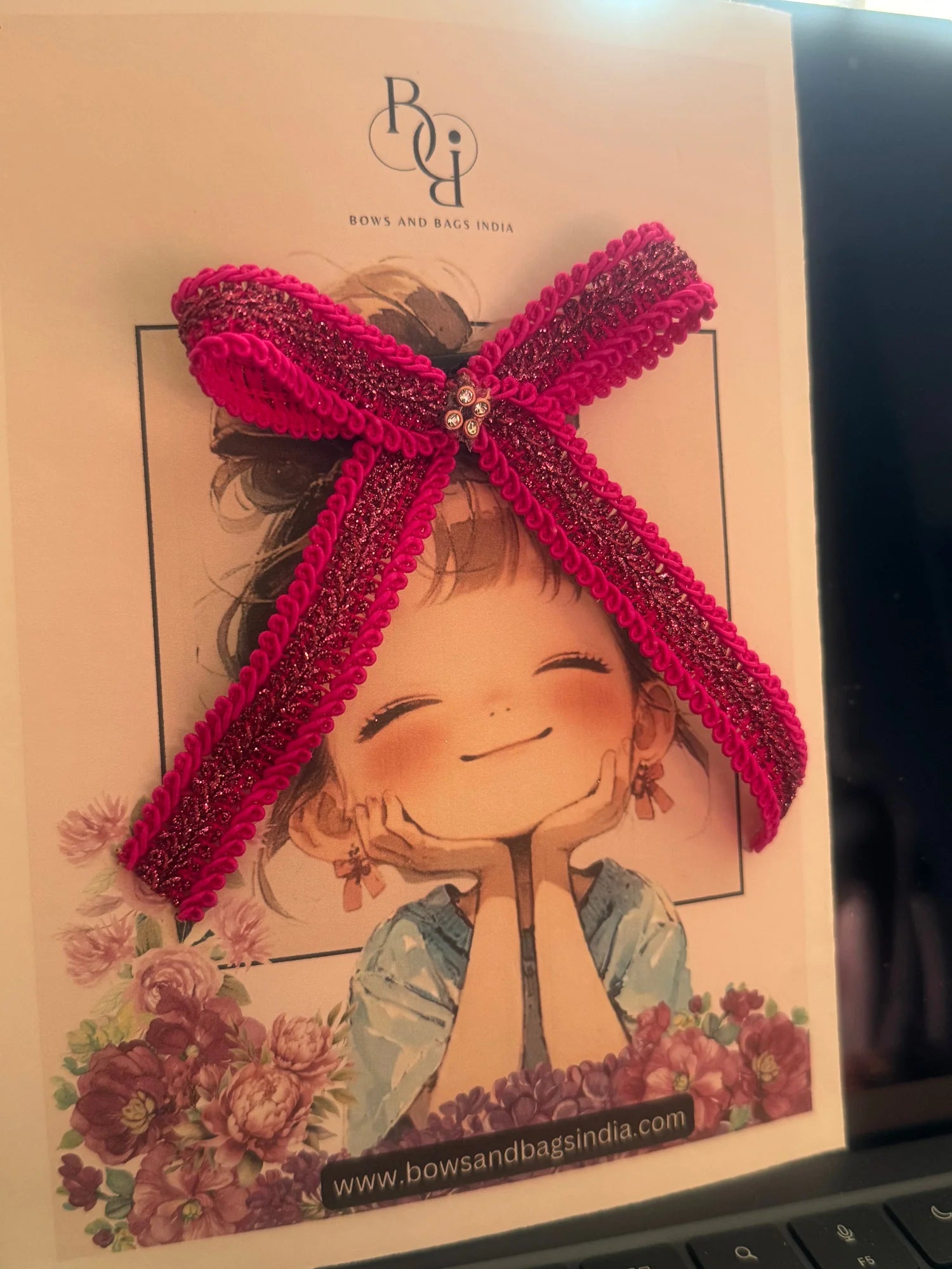 Rose Roosevelt handmade pink glitter hair bow with gold accents by Bows and Bags India, lifestyle packaging display