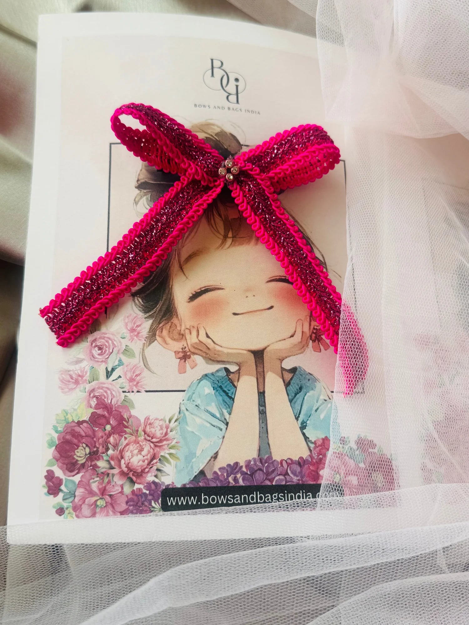 Rose Roosevelt handmade pink sequin hair bow clip by Bows and Bags India with purple gold detailing on product card