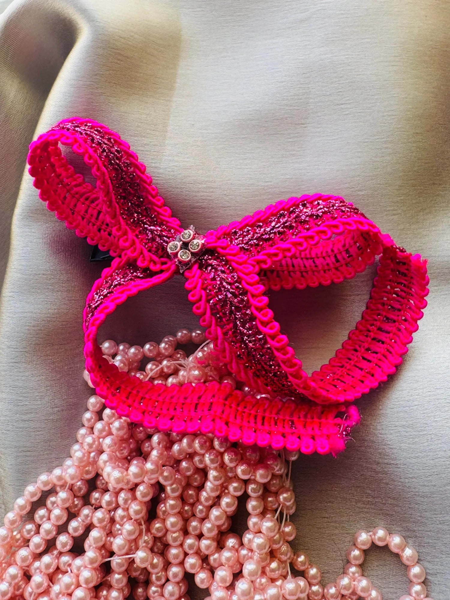Rose Roosevelt handmade hair bow with vibrant pink ruffled trim, gold glitter, and pearl bead details by Bows and Bags India