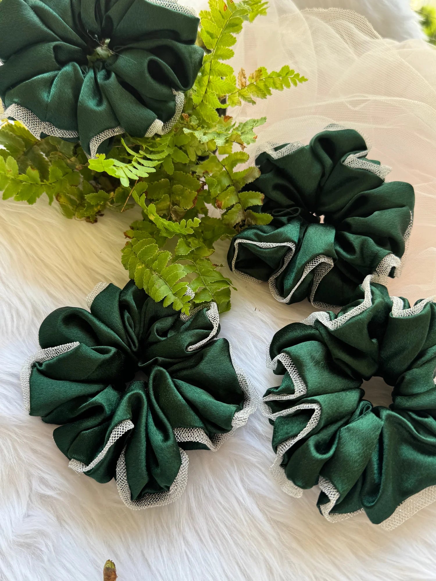 Dark green satin scrunchies with silver net borders arranged with fern leaves, handmade hair accessories by Bows and Bags