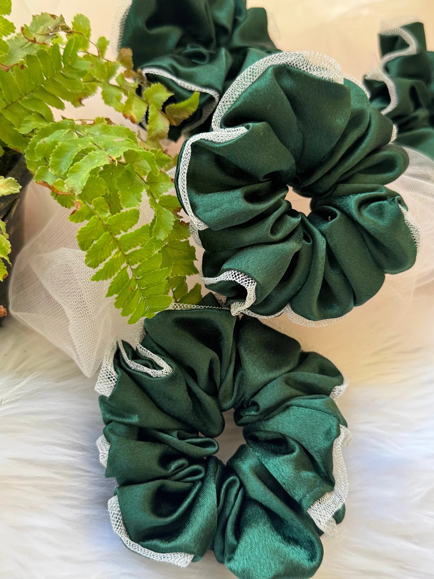 Dark green satin scrunchie with silver net border detail by Bows and Bags India, handmade hair accessory displayed with