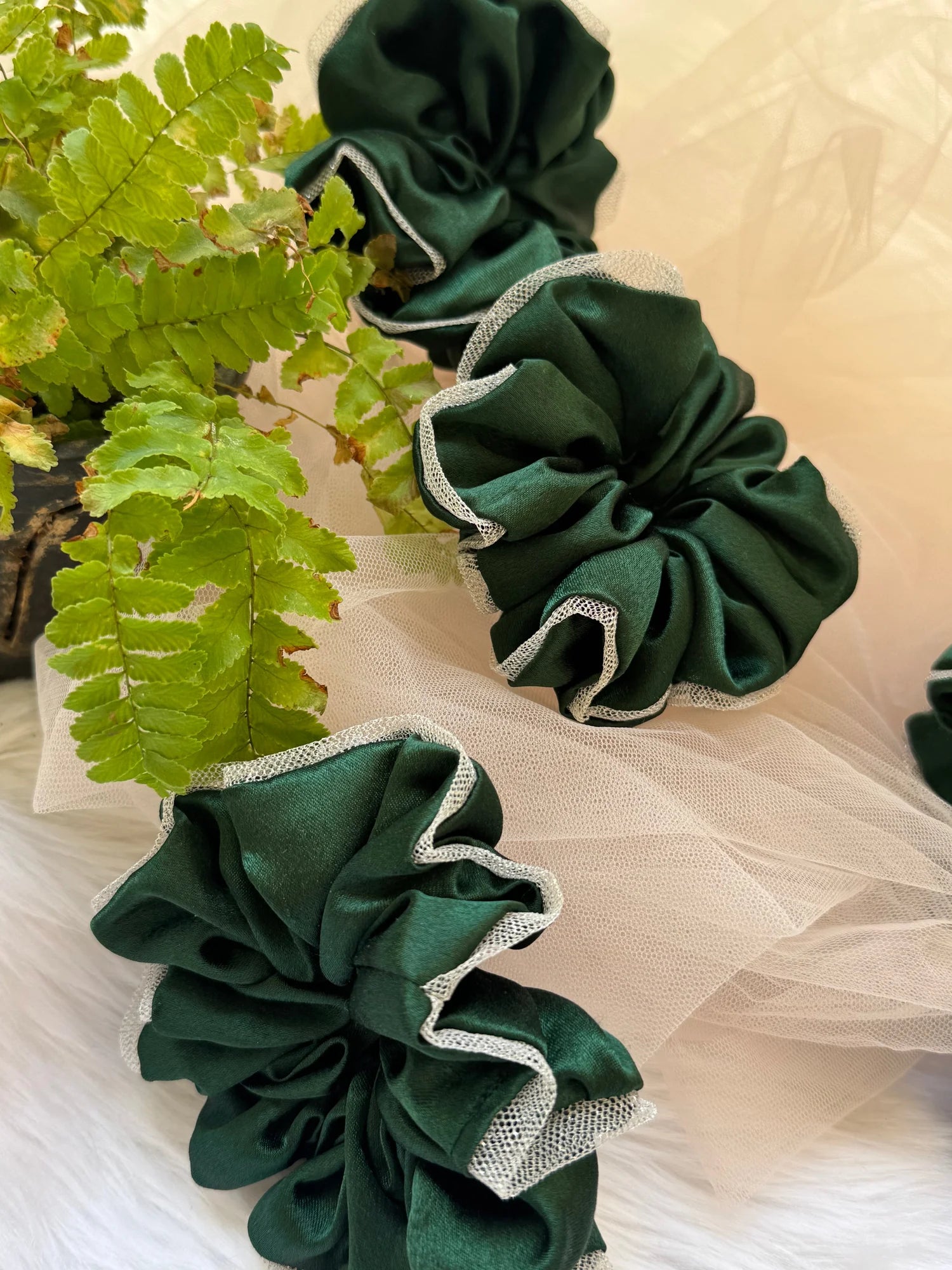 Dark green satin scrunchie with silver net border styled with fresh fern leaves by Bows and Bags India handmade hair