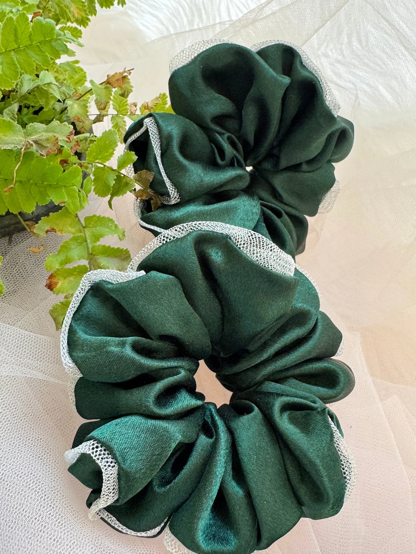 Dark green satin scrunchie with silver net border detail by Bows and Bags India, handmade hair accessory displayed on white