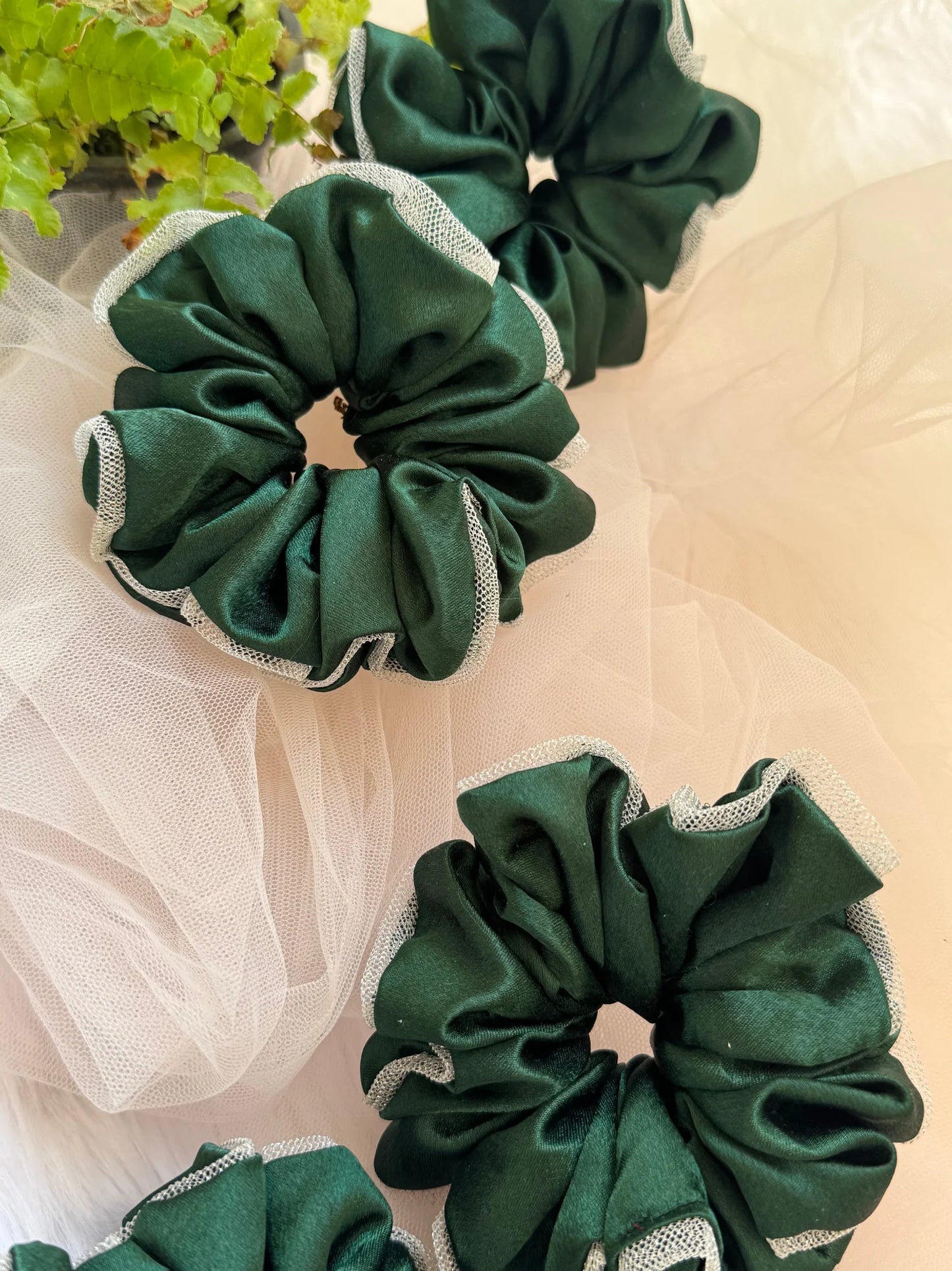 Dark green satin scrunchies with silver net border by Bows and Bags India, handmade hair accessories displayed in flat lay
