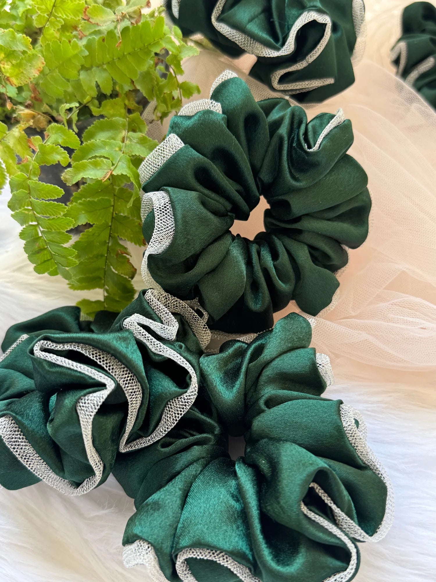 Dark green satin scrunchie with silver net border detail by Bows and Bags India, handmade hair accessory displayed with
