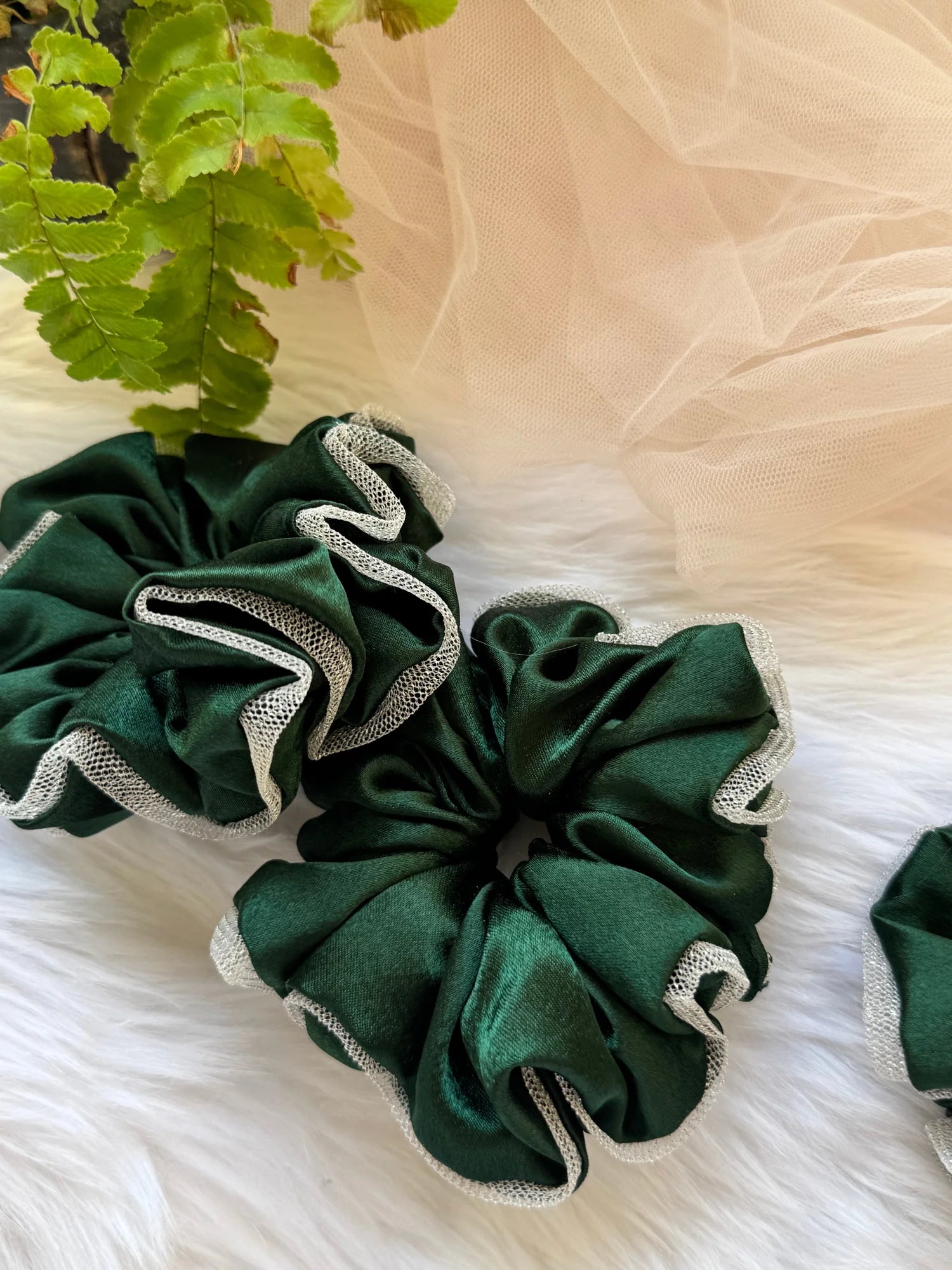 Dark green satin scrunchie with silver net border detail by Bows and Bags India, handmade hair accessory displayed on white
