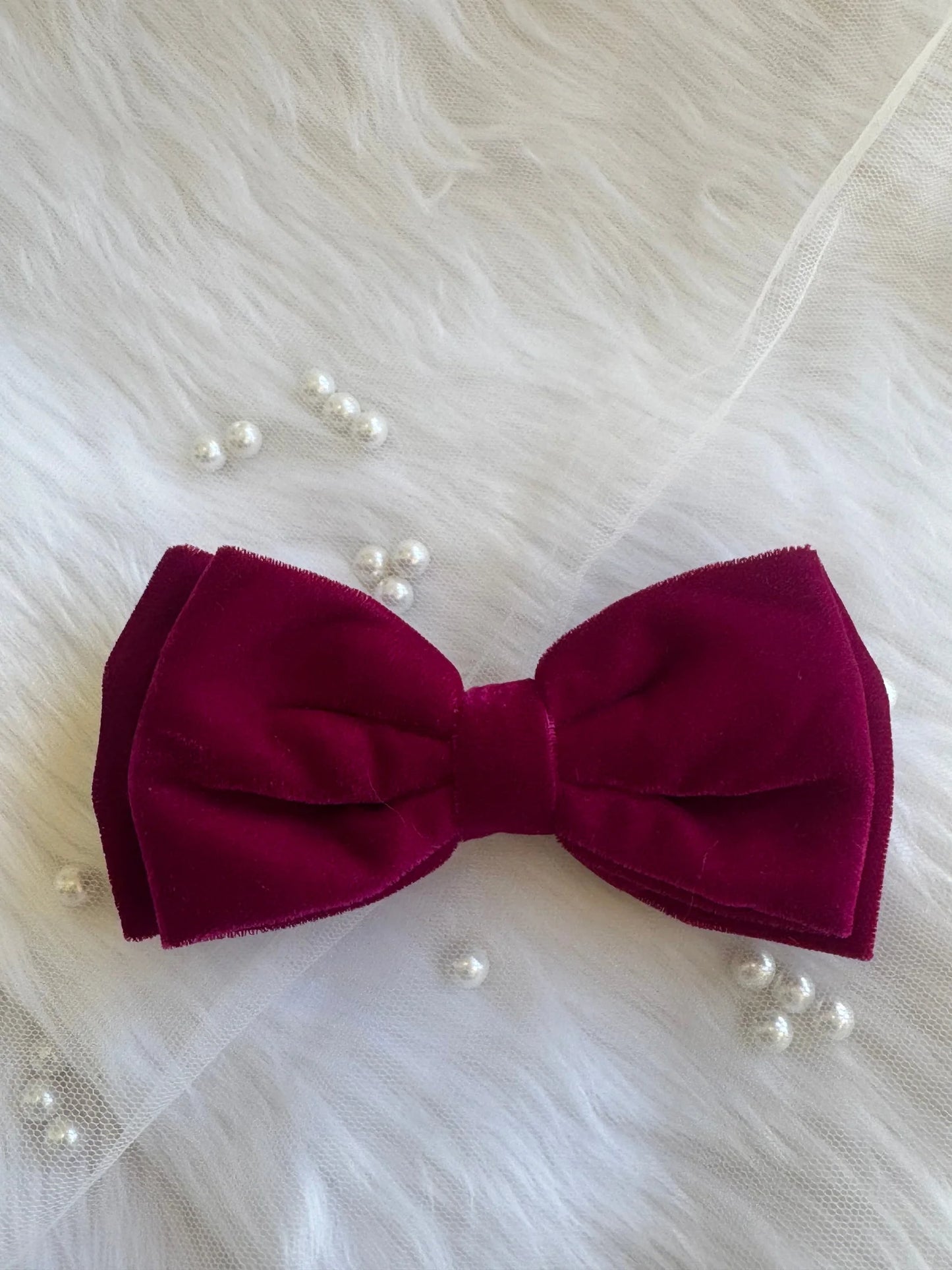 Magenta velvet hair bow with pearl accessories on white tulle by Bows and Bags India, handmade luxury styling detail