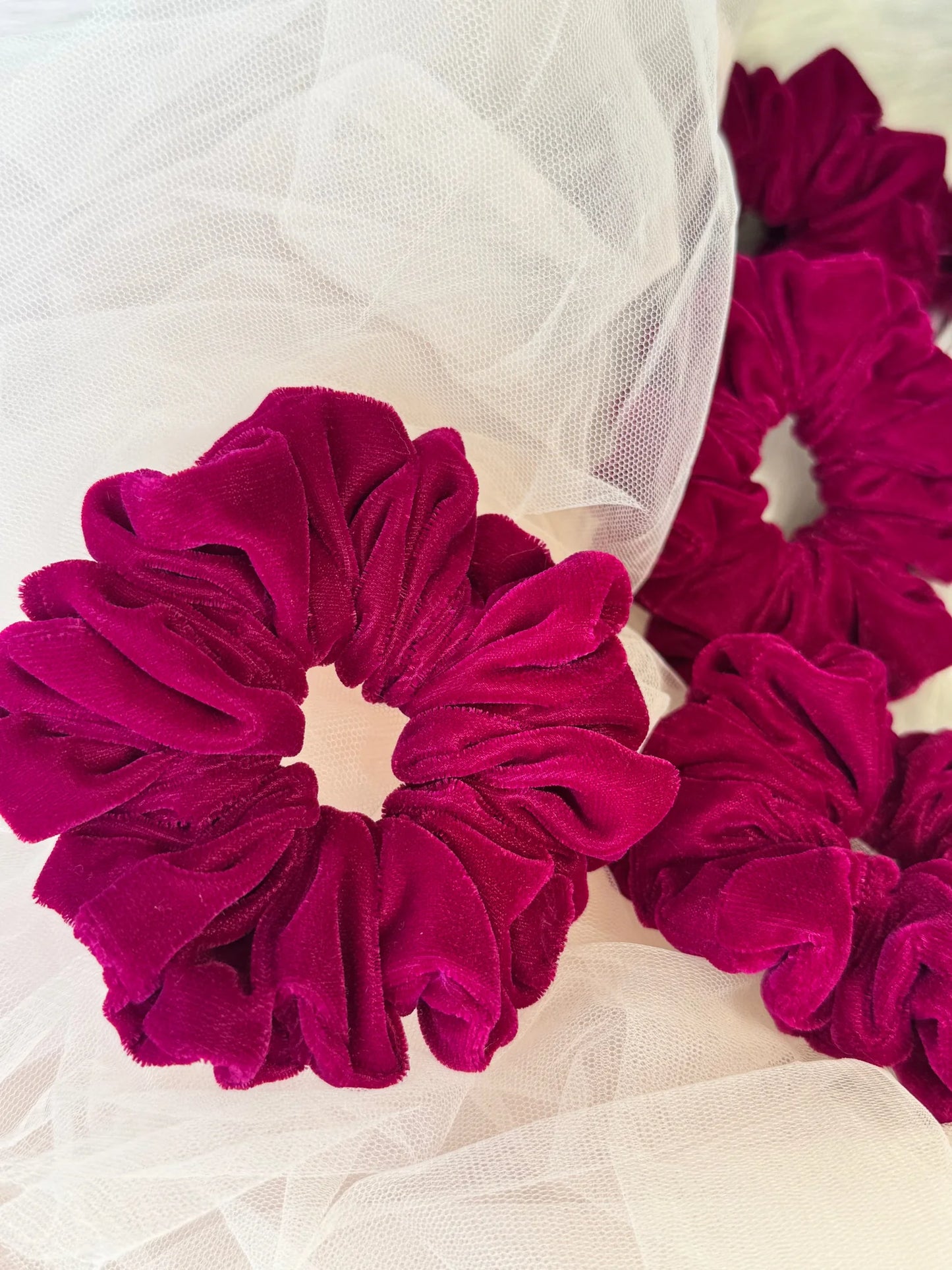 Close-up of hot pink luxe velvet scrunchie texture by Bows and Bags India, showing premium handmade fabric detail with tulle