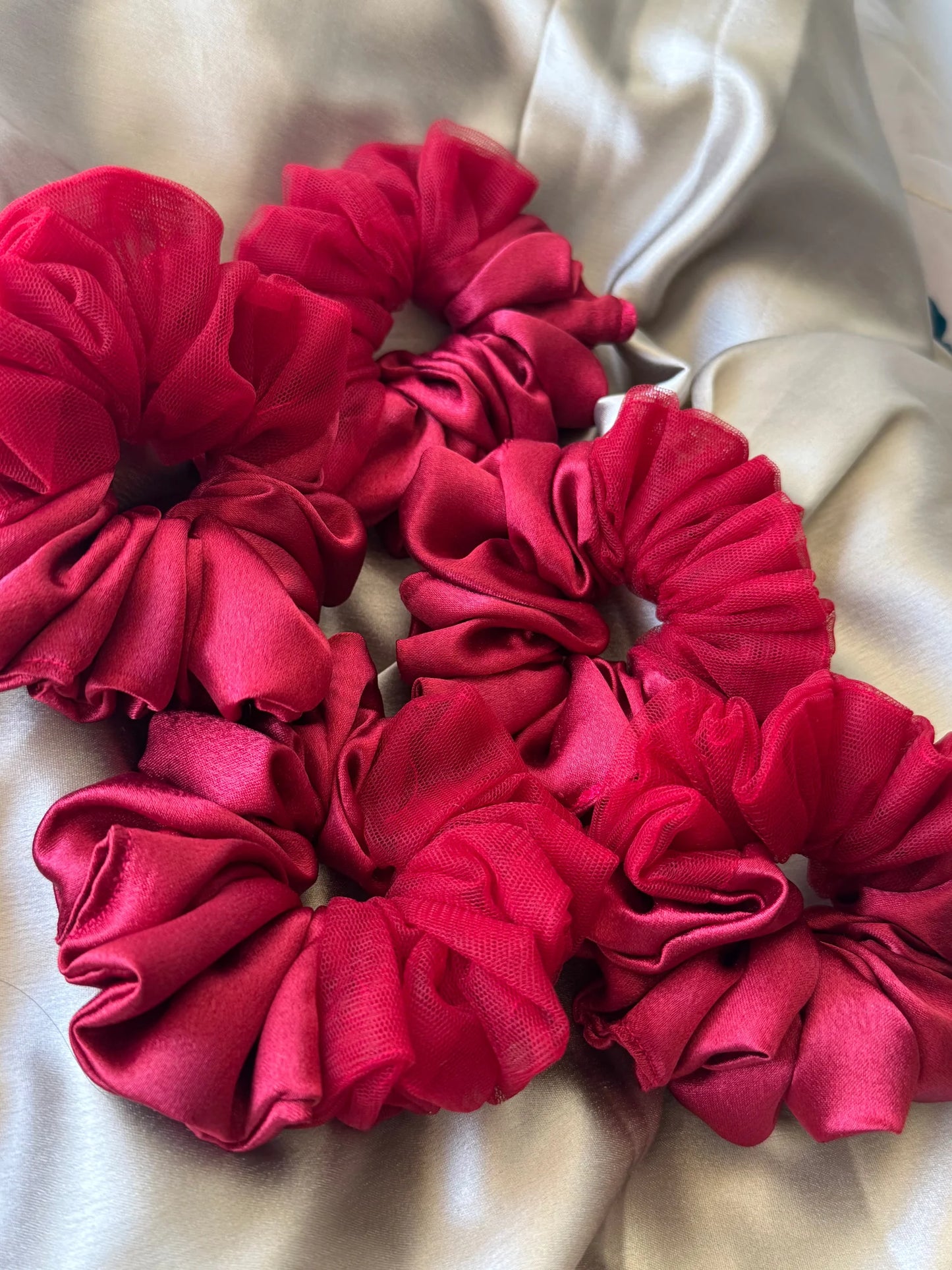 Crimson red satin and net scrunchie detail showing luxurious texture and ruffled design by Bows and Bags India handmade hair