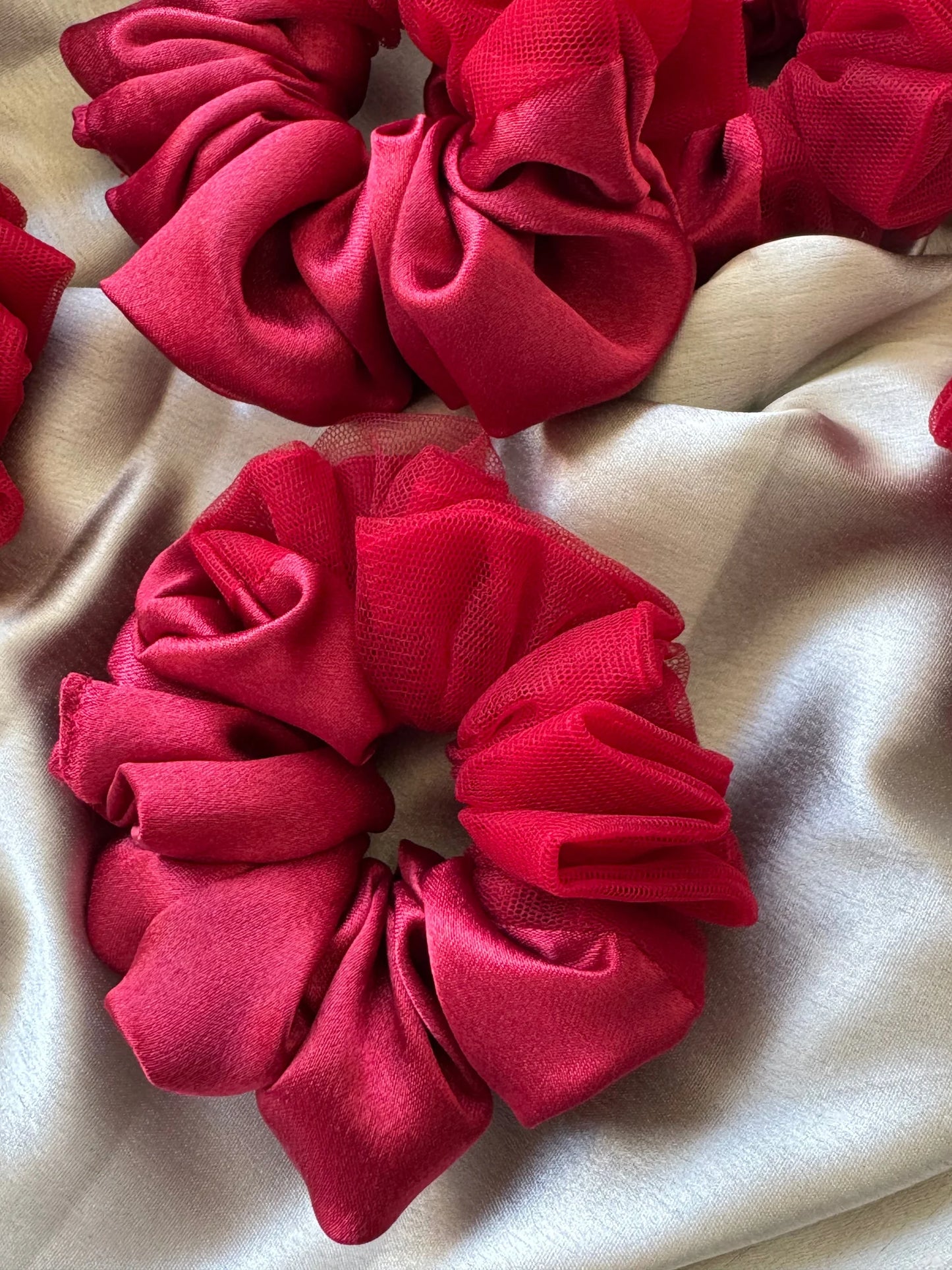 Crimson red satin scrunchie with sheer net detailing by Bows and Bags India, showing luxurious fabric texture and elegant
