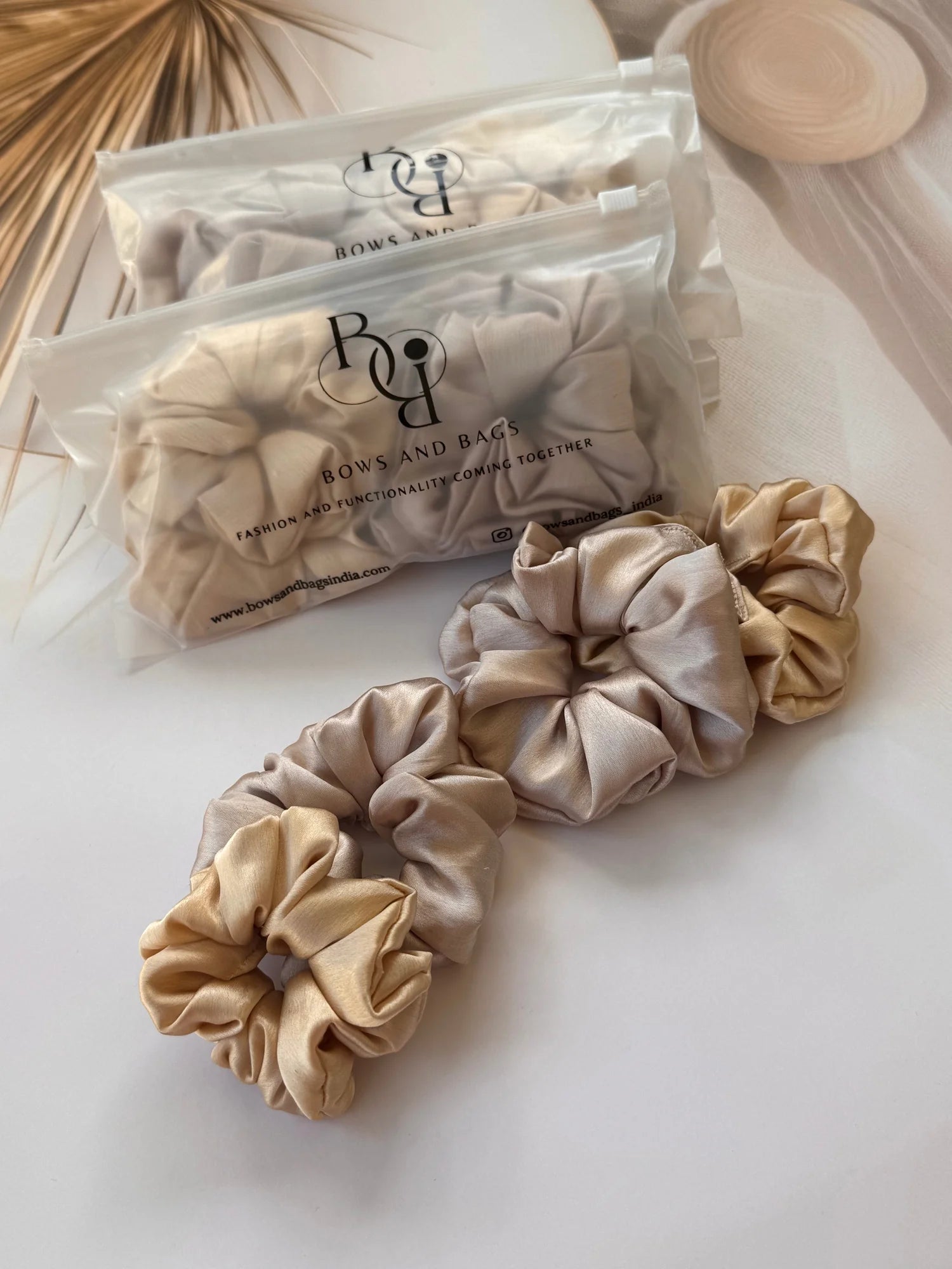 Metallic gold and champagne satin scrunchies pack displayed with packaging from Bows and Bags India handmade hair accessories