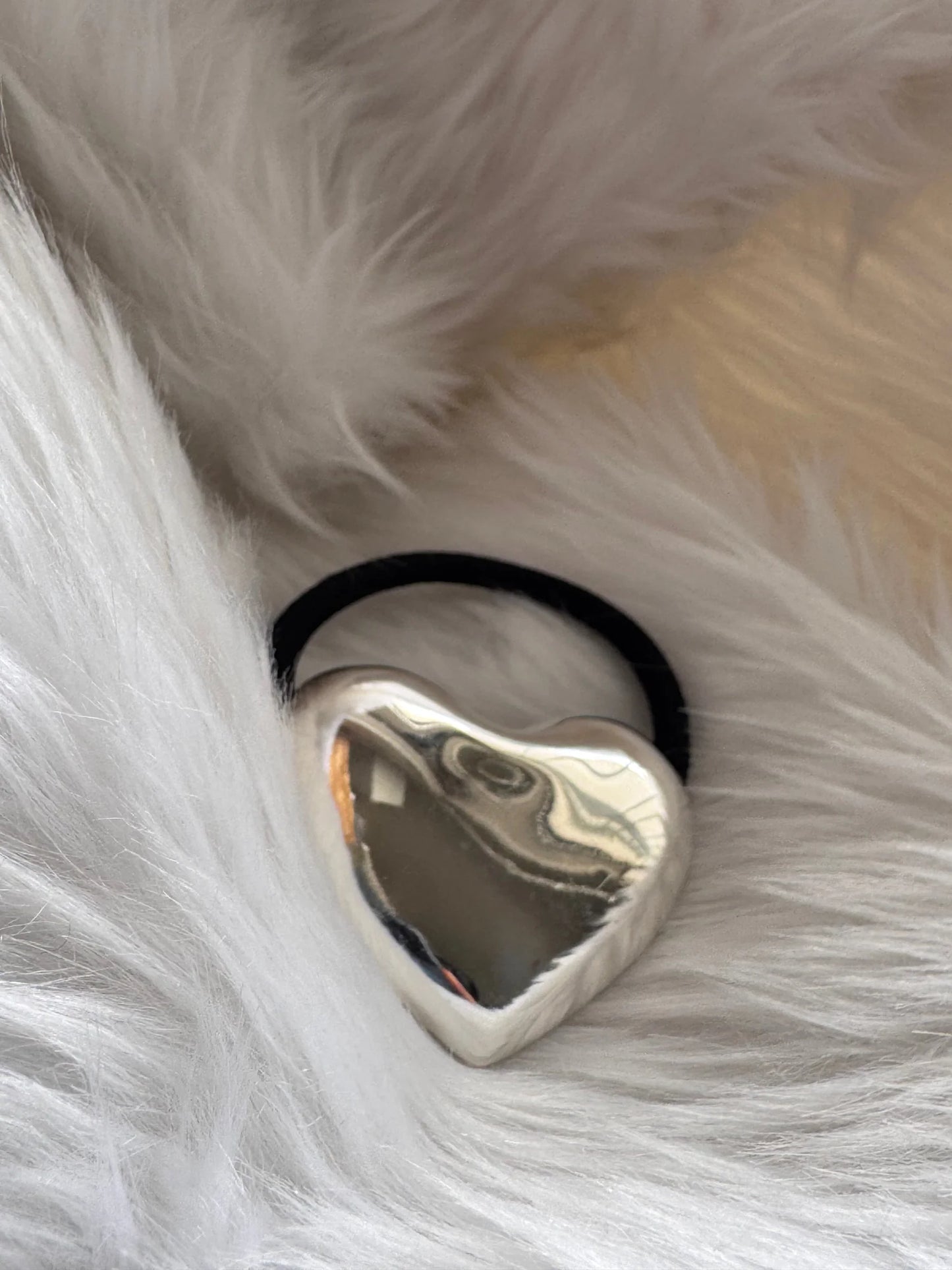 Silver heart metal rubber band with polished chrome finish on white fur, Bows and Bags India handmade hair accessory detail
