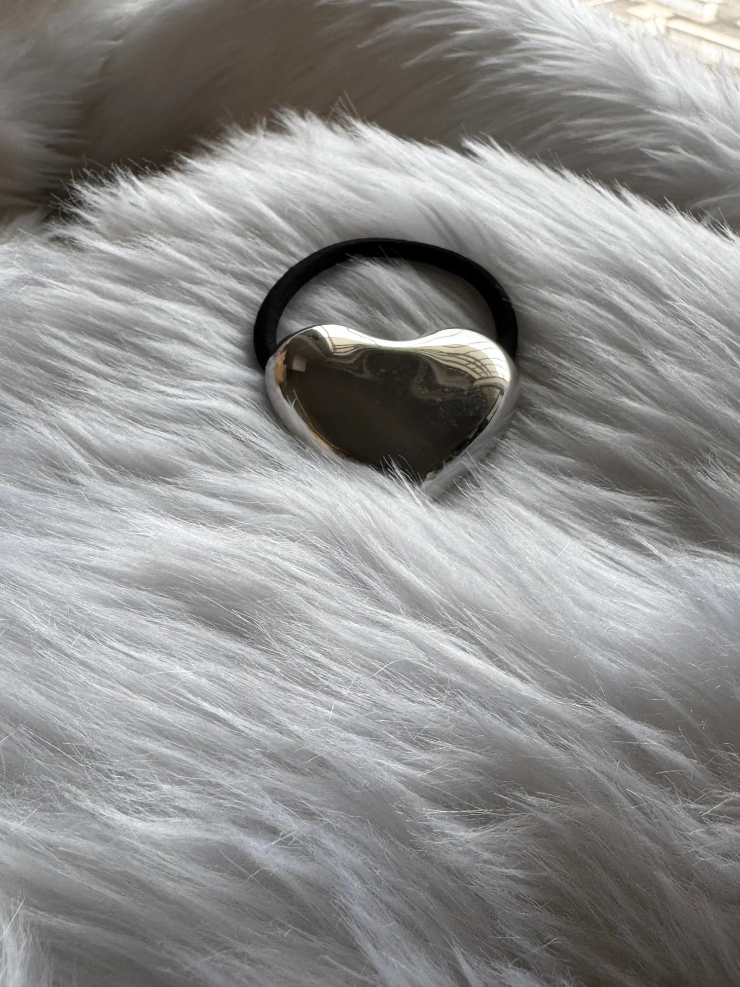Silver heart metal rubber band with polished chrome finish on white fur, Bows and Bags India handmade hair accessory