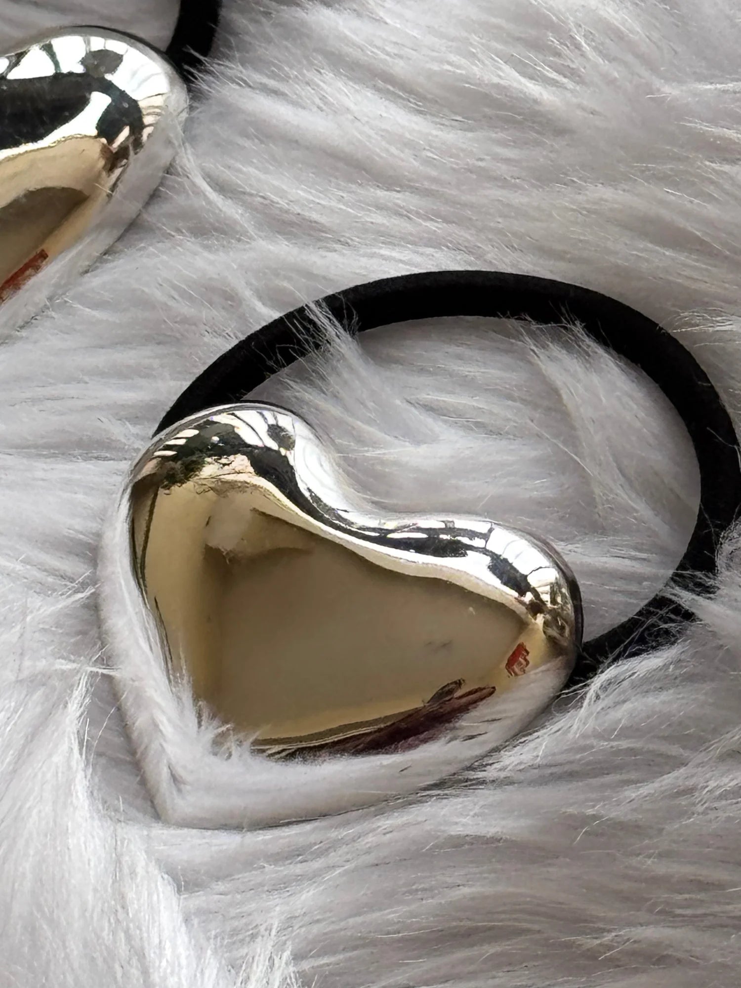 Silver Heart metal rubber band with polished chrome finish on white fur, handmade hair accessory by Bows and Bags India