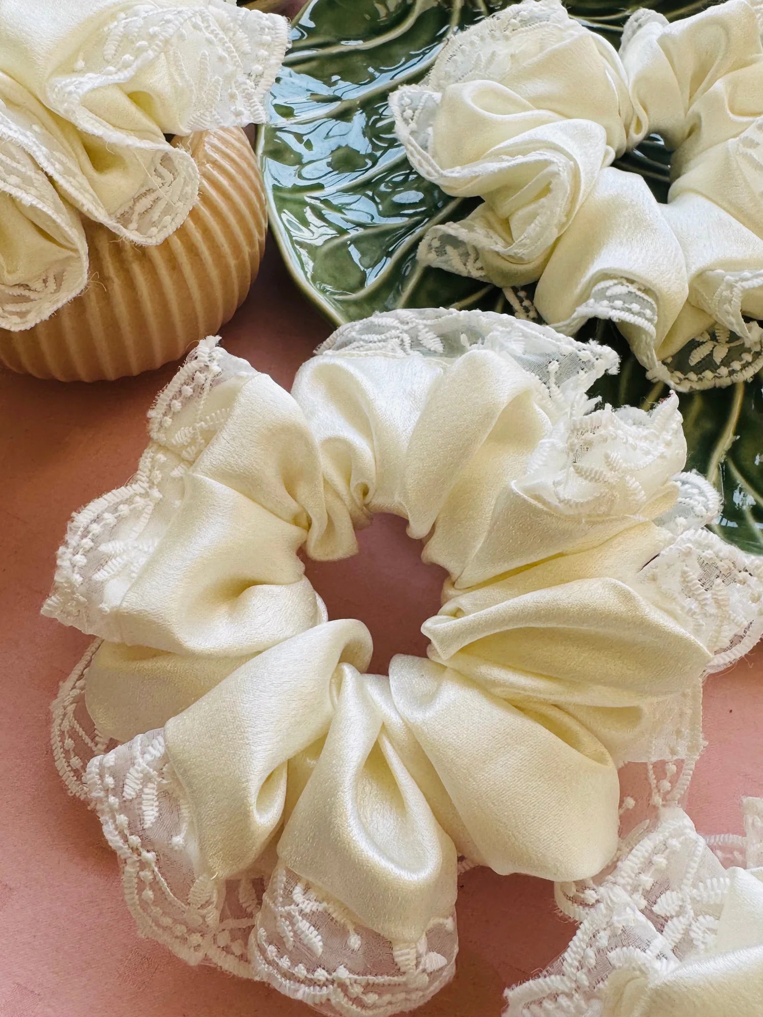 Close-up of Snow White premium satin scrunchies with delicate embroidered lace trim by Bows and Bags India