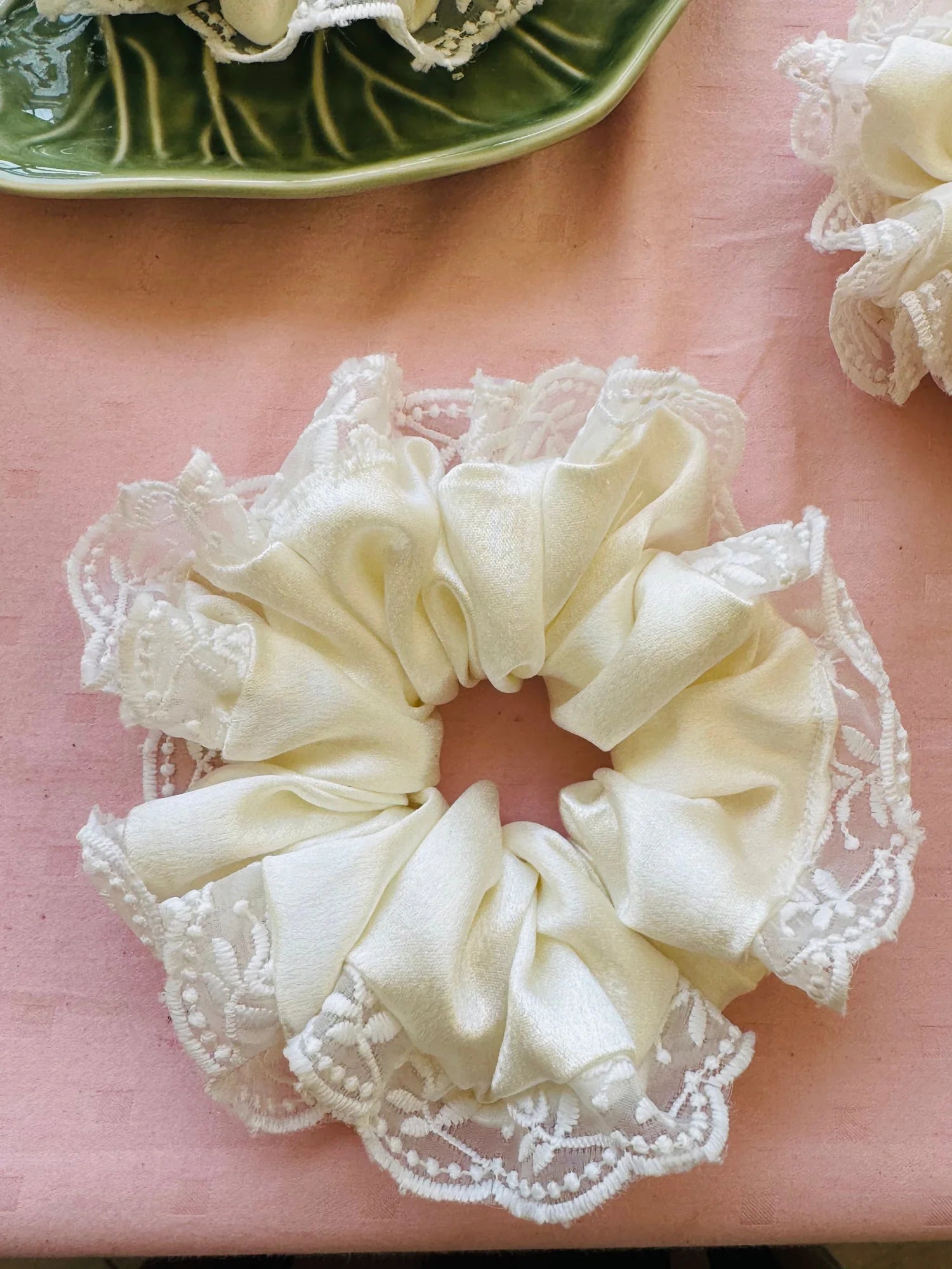 Cream satin scrunchie with delicate embroidered lace detail by Bows and Bags India, handmade designer hair accessory flat lay