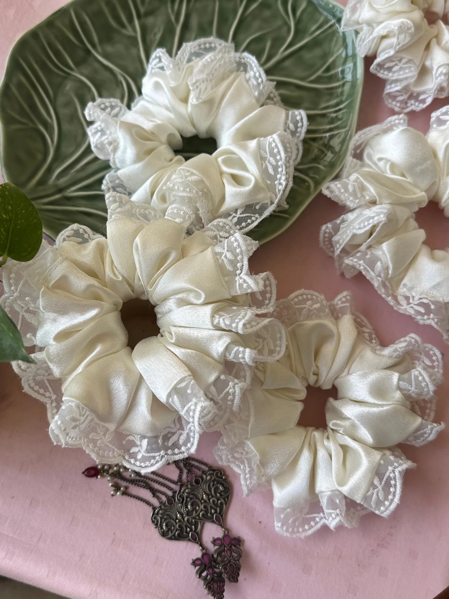 Cream satin scrunchies with delicate lace trim and ornate metal clasp detail by Bows and Bags India, handmade hair