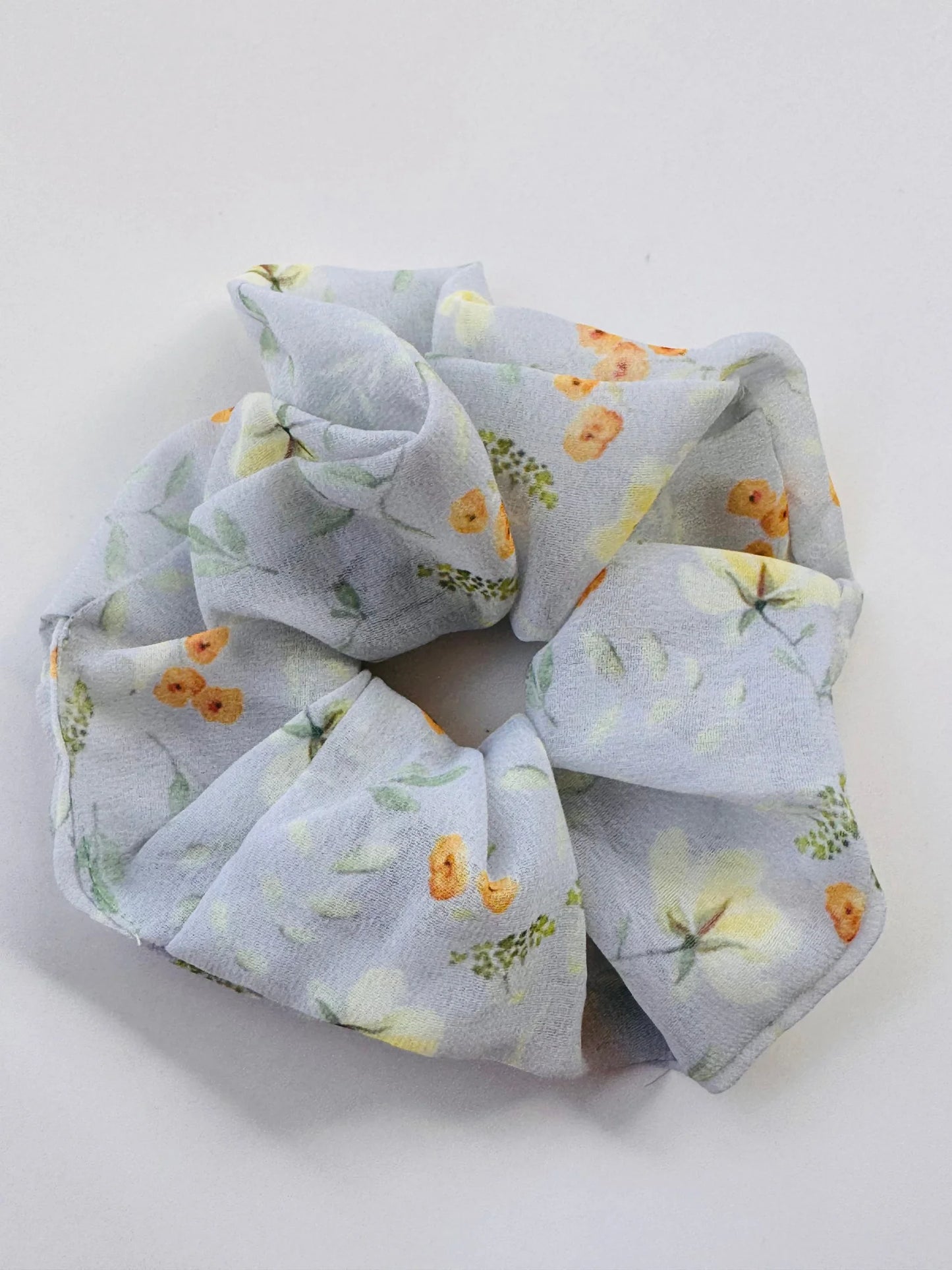 Pack of 4 floral georgette scrunchies by Bows and Bags India arranged in circular display showing vibrant prints and premium