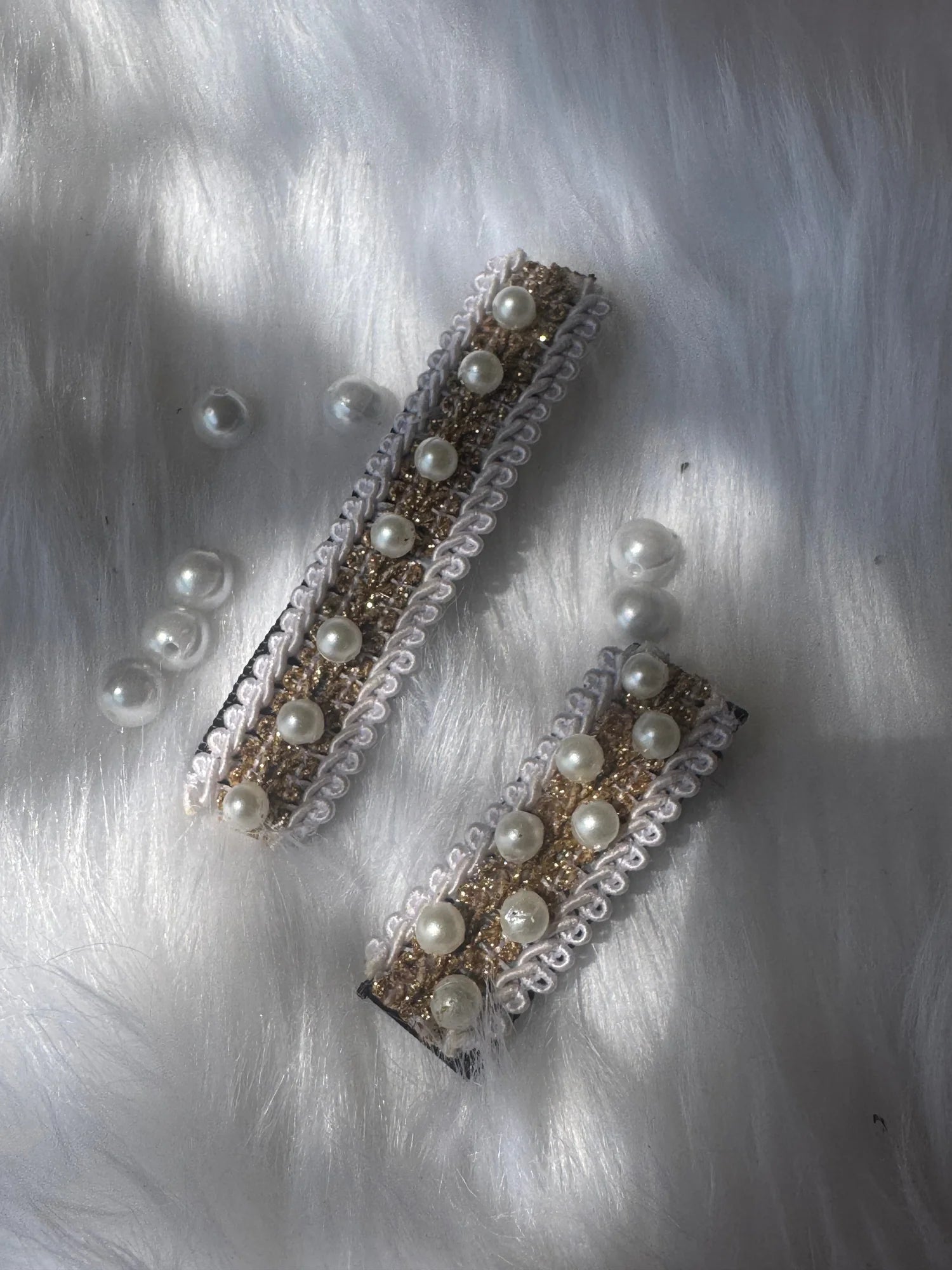 Swiss pearls handmade hair clips pair by Bows and Bags India featuring pearl embellishments on metallic base displayed on
