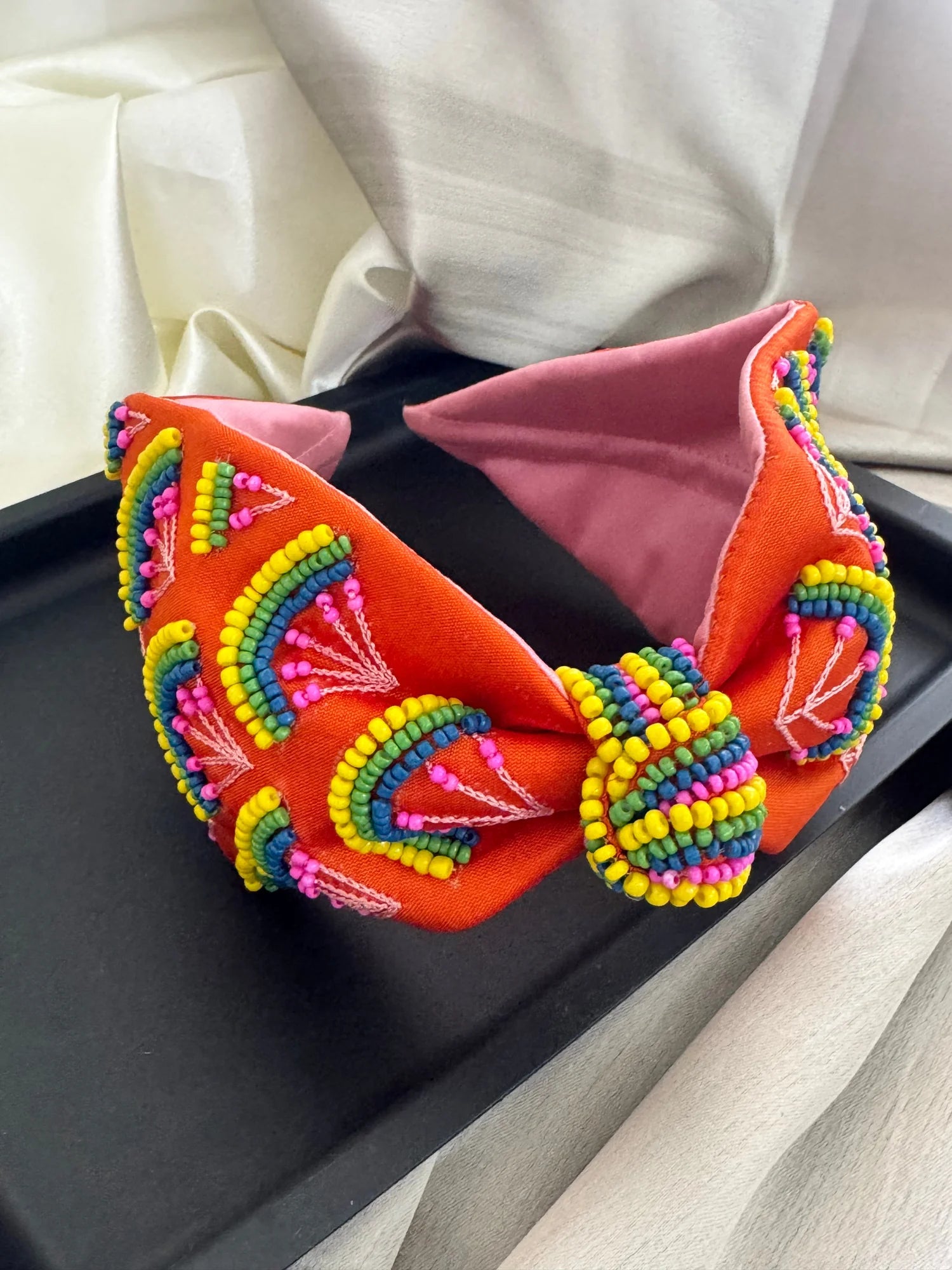 Tangerine Hawai handmade beaded satin headband by Bows and Bags India with vibrant orange fabric and multicolored bead