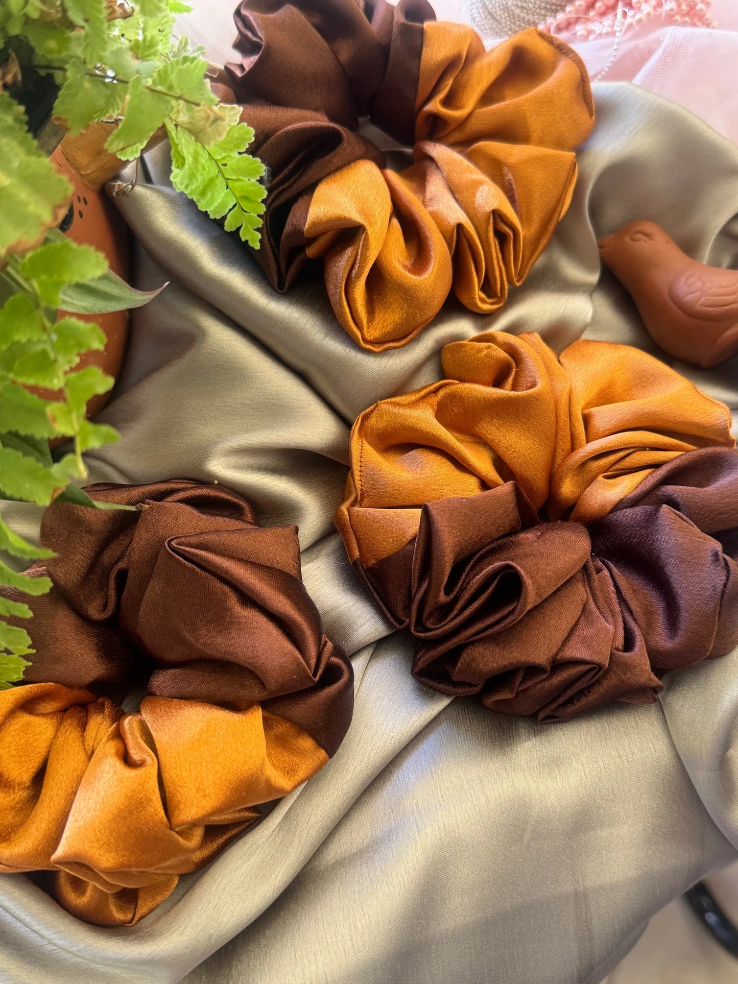 Terracotta Flower satin scrunchies in earthy gold and rich brown handmade hair accessories by Bows and Bags India displayed
