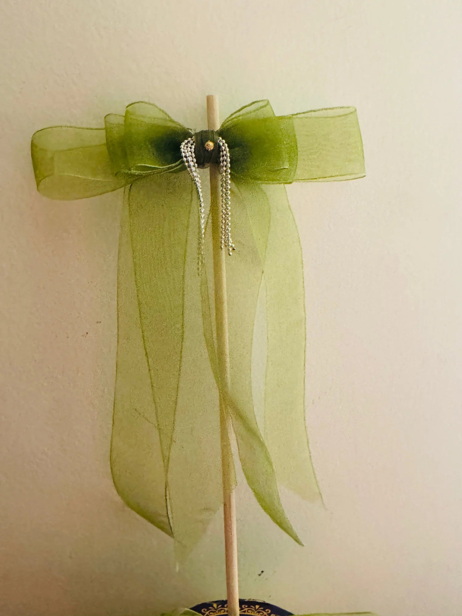 Light green organza hair bow with silver chain detail on wooden stand, Bows and Bags India handmade hair accessory