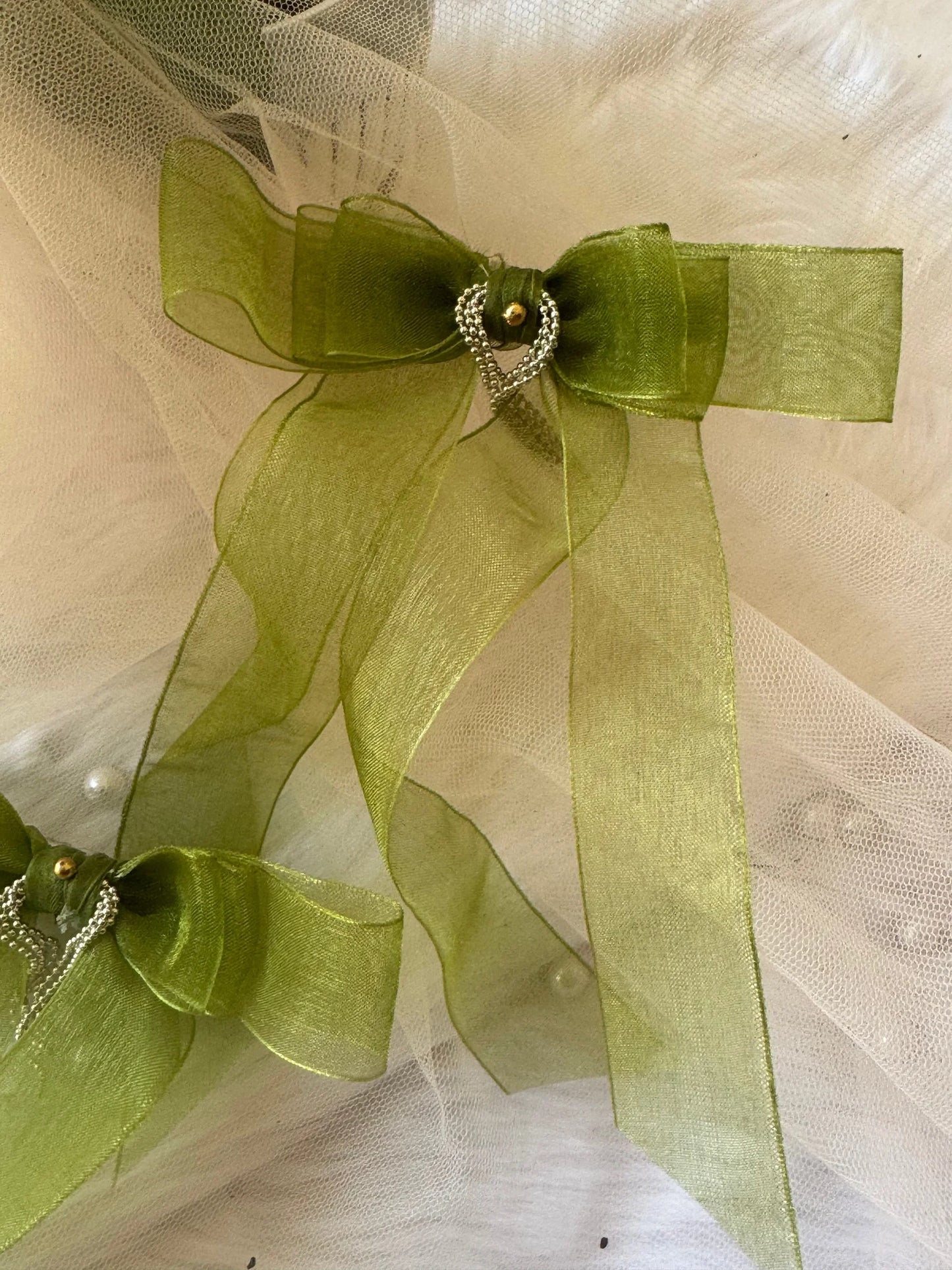 Light green organza handmade hair bow clip with silver chain detail by Bows and Bags India, close-up texture view